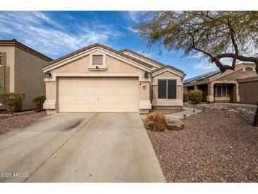 Charming one-story home featuring a two-car garage and low-maintenance desert landscaping at 11330 W Eden Mckenzie Dr, Surprise, AZ 85378