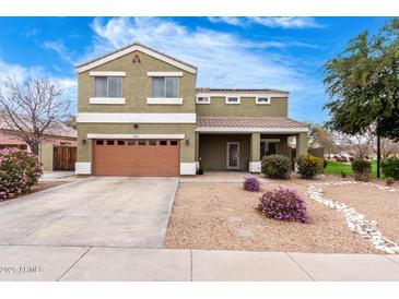 Inviting two-story home featuring low maintenance landscaping and a covered front porch at 12162 W Dreyfus Dr, El Mirage, AZ 85335