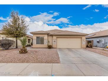 Charming single-story home featuring desert landscaping, tile roof, and a two-car garage at 12530 W Jackson St, Avondale, AZ 85323