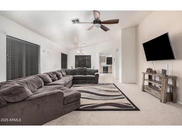 Spacious living room with comfortable sectional sofa and stylish area rug at 12530 W Jackson St, Avondale, AZ 85323
