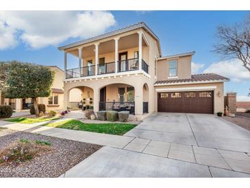 Inviting two-story home with a charming front porch and second story balcony at 13432 N 154Th Ln, Surprise, AZ 85379