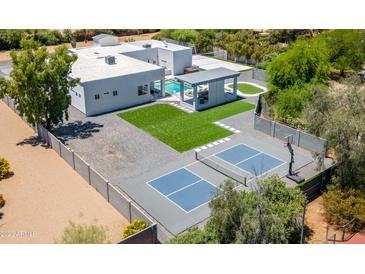 A modern home featuring a pickleball court, pool, cabana, artificial turf, and meticulous landscaping at 13613 N 76Th St, Scottsdale, AZ 85260