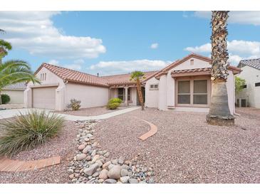 Charming single-story home with a desert landscape, tile roof and a two car garage at 15525 W Clear Canyon Dr, Surprise, AZ 85374