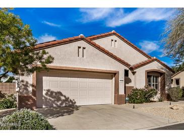 Attractive single-story home with desert landscaping, a two-car garage, and a well-kept exterior at 16172 W Starlight Dr, Surprise, AZ 85374