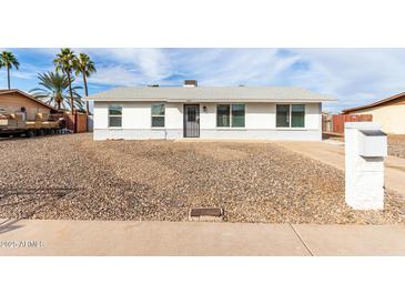 Charming single story home featuring neutral paint, gravel landscaping and a secure front door at 1640 W Charleston Ave, Phoenix, AZ 85023