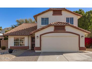 Charming two-story home featuring a red tile roof, cream stucco and an attached two-car garage at 18421 N 12Th Way, Phoenix, AZ 85022