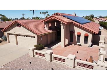Charming single-story home featuring solar panels, desert landscaping, and a two-car garage at 26637 S New Town Dr, Sun Lakes, AZ 85248