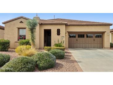 Charming single-story home with a two-car garage, desert landscaping, and a tile roof at 29588 N 129Th Dr, Peoria, AZ 85383