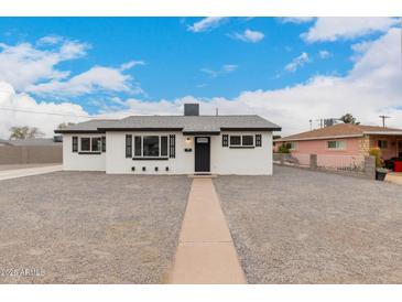 Charming renovated single-story home with crisp white paint, black trim, and xeriscaped yard at 3009 W Alice Ave, Phoenix, AZ 85051