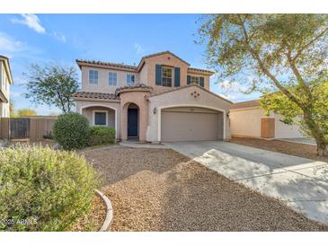 Inviting two-story home featuring a well-manicured front yard, a large driveway, and an attached two-car garage at 44983 W Sage Brush Dr, Maricopa, AZ 85139