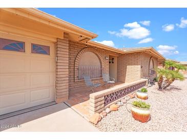 Charming single-story home with a brick facade, front patio, and manicured landscaping at 4510 E Emelita Ave, Mesa, AZ 85206