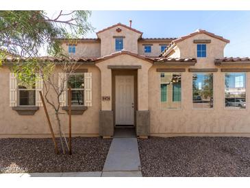 Charming two-story home featuring a beautiful stucco exterior, arched entry and well-manicured landscaping at 5474 W Fulton St, Phoenix, AZ 85043