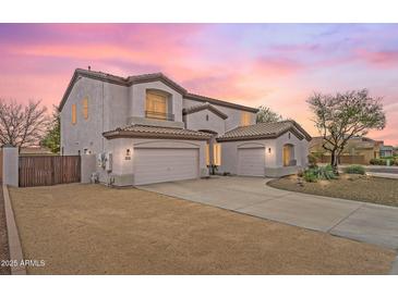 Charming two-story home featuring a three-car garage and desert landscaping at 7387 W Remuda Dr, Peoria, AZ 85383