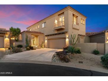 Stunning two-story home with desert landscaping, tile roof, and balcony in a quiet neighborhood at 9280 E Thompson Peak Pkwy # 25, Scottsdale, AZ 85255