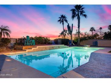 Sparkling pool with lounge chairs and palm trees, perfect for relaxing evenings and outdoor entertainment at 9921 E Doubletree Ranch Rd, Scottsdale, AZ 85258