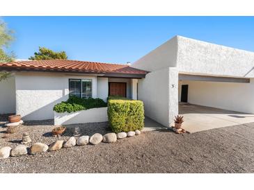 Charming single-story home with a red-tile roof, inviting entrance, and a two-car carport at 100 N Lazy Fox Rd # 3, Wickenburg, AZ 85390