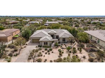 Stunning aerial view of custom home with desert landscaping and charming courtyard entry at 7829 E Softwind Dr, Scottsdale, AZ 85255