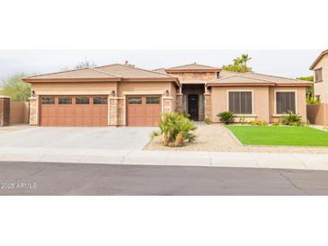 Charming single-story home featuring a two-car garage and well-manicured front yard at 15146 W Highland Ave, Goodyear, AZ 85395