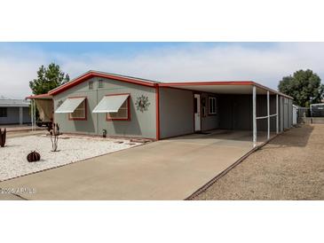 Charming single-story home with carport and simple landscaping of rocks and desert plants at 17258 N 66Th Dr, Glendale, AZ 85308