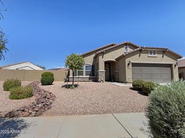 Charming single-story home with a well-maintained, low-maintenance desert landscape and beautiful stone accents at 17542 W Pinnacle Vista Dr, Surprise, AZ 85387