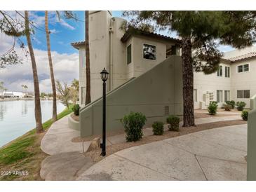 Neutral exterior with stairs, landscaping, and waterfront view, perfect for relaxing by the water at 1825 W Ray Rd # 2116, Chandler, AZ 85224