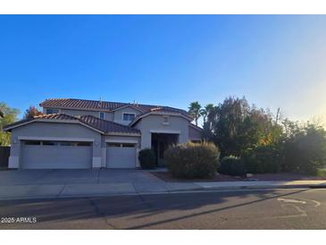 Inviting two-story home with a three-car garage and mature landscaping at 2539 E Hazeltine Way, Chandler, AZ 85249