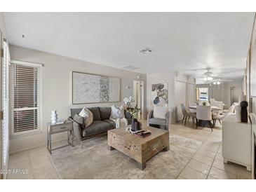 Comfortable living room featuring a modern sofa, stylish decor, and an inviting dining area at 316 W Tonopah Dr # 3, Phoenix, AZ 85027