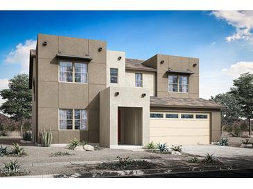 A modern two-story home boasts desert landscaping and a three-car garage at 3908 S 241St Ln, Buckeye, AZ 85326