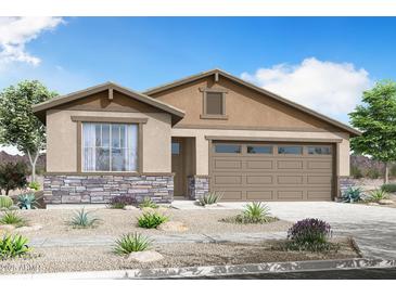 Charming single-story home with a two-car garage, stone accents, and desert landscaping at 3915 S 241St Ln, Buckeye, AZ 85326