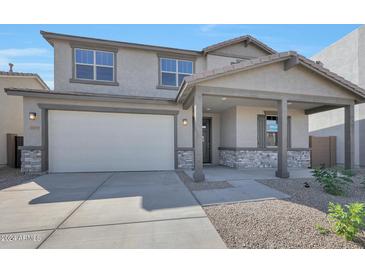 Charming two-story home featuring a covered porch, stone accents and a two car garage at 4069 W Nora Dr, San Tan Valley, AZ 85144