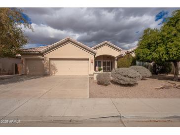 Charming single-story home with a desert landscaped front yard and a three car garage at 4552 E Chuckwalla Cyn, Phoenix, AZ 85044