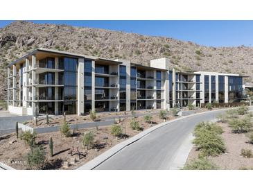 Modern condo building with balconies and desert landscaping nestled at the base of a mountain at 5000 N Camelback Ridge Rd # 210, Scottsdale, AZ 85251