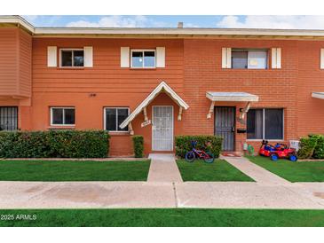 Charming townhouse with well-maintained lawn, colorful bikes, and inviting curb appeal at 6507 N 44Th Ave, Glendale, AZ 85301