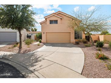 Two story home with a two car garage, a large driveway, and desert landscaping at 6717 E Saddleback Cir, Mesa, AZ 85215