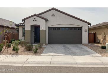 Charming single-story home featuring a well-manicured front yard and an attached two-car garage at 8907 W Bethany Heights Dr, Glendale, AZ 85305