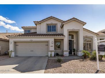 Charming two-story home boasts a tile roof, desert landscaping, and a convenient two-car garage at 901 N Woodburne Dr, Chandler, AZ 85224