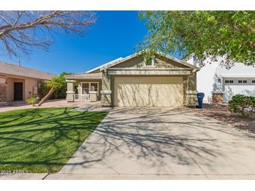 Charming single-story home with a well-manicured lawn and inviting front porch at 10704 E Plata Ave, Mesa, AZ 85212