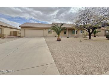 Charming single story home with low maintenance landscaping, long driveway, and tile roof at 14545 S Cherry Hills Dr, Arizona City, AZ 85123