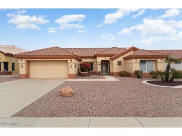 Charming home featuring a two-car garage, front yard desert landscaping, and a welcoming front entrance at 15924 W Falcon Ridge Dr, Sun City West, AZ 85375