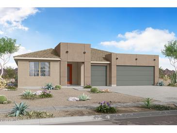 Stunning modern home featuring desert landscaping, neutral colors, and a spacious two-car garage at 18444 W Mohave St, Goodyear, AZ 85338