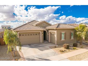 Charming single-story home featuring a three-car garage and well-maintained landscaping at 24478 N 166Th Ave, Surprise, AZ 85387