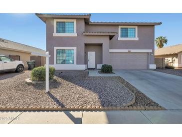 Charming two-story home with a well-manicured front yard and a two-car garage at 3023 W Quail Ave, Phoenix, AZ 85027