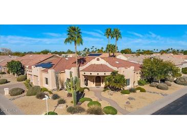 Beautiful home featuring desert landscaping, a tiled roof, and solar panels for energy efficiency at 9160 E Wethersfield Rd, Scottsdale, AZ 85260