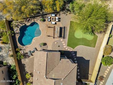 Aerial view of the private backyard featuring a pool, pergola, putting green, and lounge area at 1644 N Lynch --, Mesa, AZ 85207