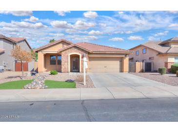 Charming single story home with well-manicured lawn and a two-car garage at 2486 E Espada Trl, Casa Grande, AZ 85194