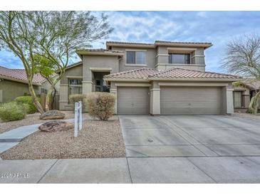 Charming two-story home with a three-car garage and desert landscaping at 2737 W Eastman Dr, Anthem, AZ 85086