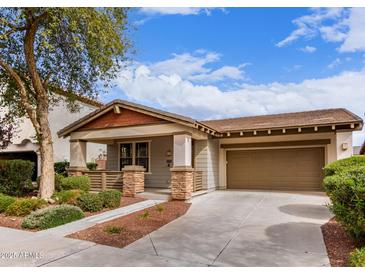 Charming single-story home with a two car garage, landscaped yard, and inviting covered porch at 3143 N Evergreen St, Buckeye, AZ 85396