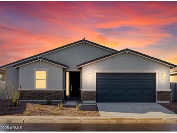 Charming single-story home with a two-car garage and desert landscaping, perfect for a starter home at 3547 E Alexander Dr, San Tan Valley, AZ 85143