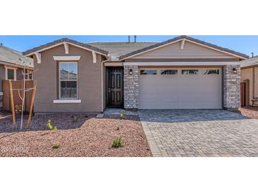 Beautiful single-story home featuring stone accents, a two-car garage, and low maintenance desert landscaping at 5401 W Las Palmaritas Dr, Glendale, AZ 85302