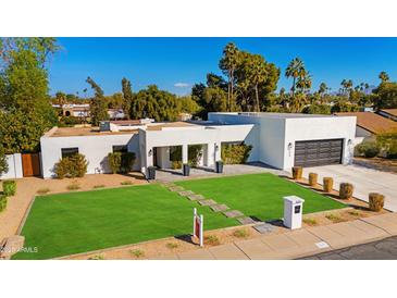 Beautiful, modern single-Gathering home with a well-manicured lawn and appealing desert landscaping at 5650 E Presidio Rd, Scottsdale, AZ 85254